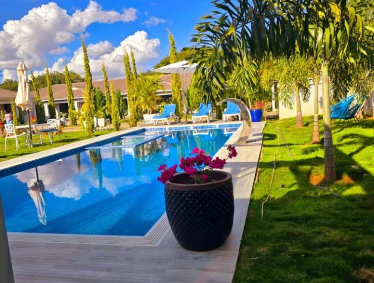 Swimming pool with scenic views at Canvas Luxury Villas Lusaka. Outdoor pool surrounded by gardens at Canvas Luxury Villas.