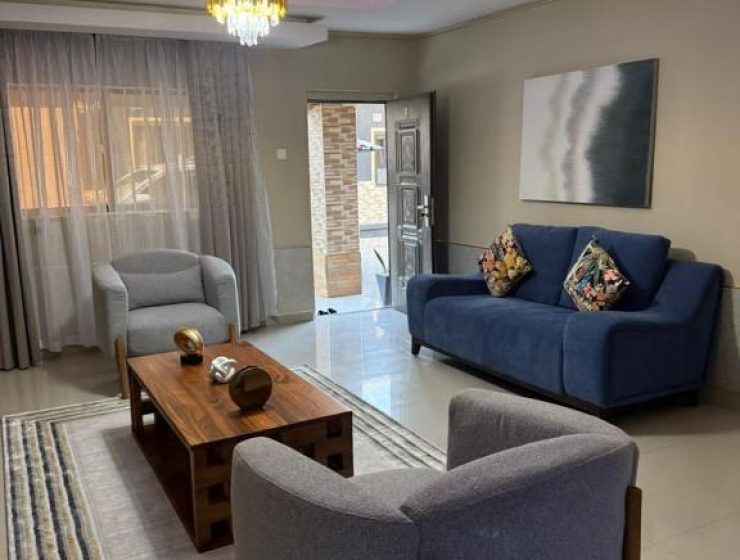 Open‑plan living room at Sazeesha Apartments with modern furniture and natural lighting. Spacious lounge area in Sazeesha Apartments featuring a flat‑screen TV and comfortable seating.